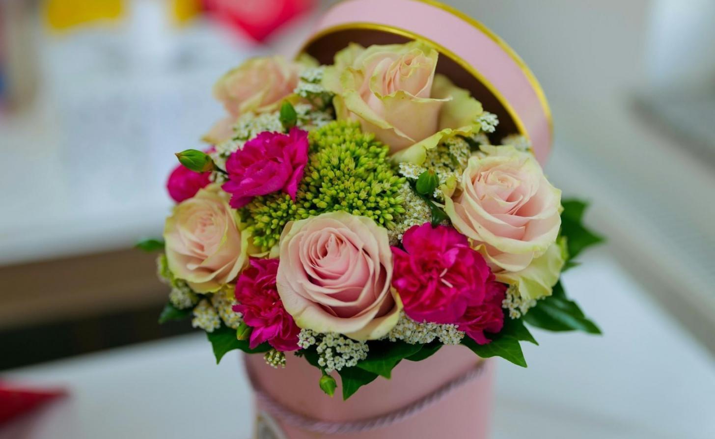 Expert florist carefully preparing premium flower arrangements