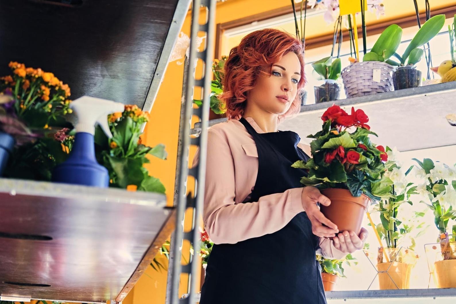 Professional flower arrangement creation process showing attention to detail